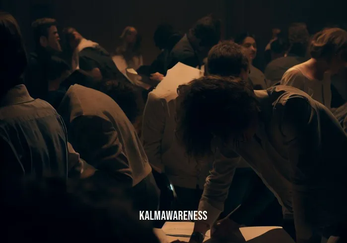 mindfulness discussion questions _ Image: A crowded and noisy conference room filled with people talking over each other, looking stressed. Image description: The room is dimly lit, and participants are hunched over their papers, appearing overwhelmed.