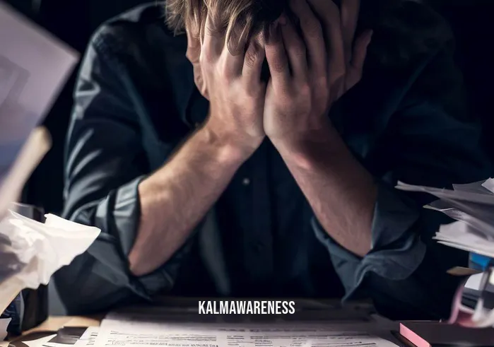 8 minute power meditation _ Image: A close-up of a person sitting at their cluttered desk, surrounded by work documents and a computer.Image description: The individual looks overwhelmed, with their head in their hands, seemingly buried in their tasks and feeling the pressure.