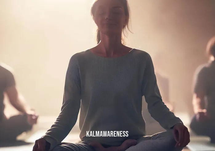 8 minute power meditation _ Image: A yoga and meditation studio, with soft lighting and mats laid out neatly on the floor.Image description: The person participates in a guided meditation session, surrounded by others in a calming environment. They sit cross-legged, their expression tranquil and focused.